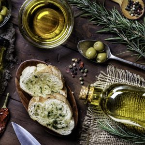 Snack or appetizer of garlic basil and olive oil bruschetta on table in a rustic kitchen. Directly above view.